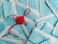 Red Chinese lucky charm representing China, on a background of blue disposable surgical masks