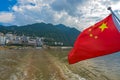 Red Chinese national flag fluttering on a sightseeing ship on Yangtze River