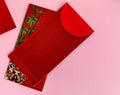 Red Chinese New Year envelopes with pink background. Chinese New Year concept.