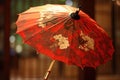 Red chinese umbrella with floral patterns on dark background, created using generative ai technology Royalty Free Stock Photo