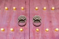 Red chinese wooden door with metal knocker and golden knocker nails in Beijing,China Royalty Free Stock Photo