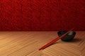 Red Chopsticks, Black Bowl on a Wooden Surface Royalty Free Stock Photo
