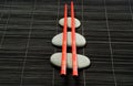 Red chopsticks on pebbles Royalty Free Stock Photo