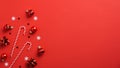 Red Christmas background with red baubles decoration, candy canes and confetti. Flat lay, top view, copy space. Xmas banner mockup Royalty Free Stock Photo
