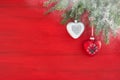 Red Christmas background with fir branches, heart and snow. Copy