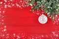 Red Christmas background with fir tree branch and white Christmas ornaments. Copy space. Royalty Free Stock Photo