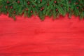 Red Christmas background. Christmas fir tree with decoration on red wooden background Royalty Free Stock Photo