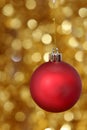 Red christmas ball against golden background