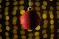 Red Christmas ball on a background of garlands. Christmas and new year concept. Bokeh garlands. Royalty Free Stock Photo