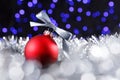 Red christmas ball and blured purple lights at the background Royalty Free Stock Photo