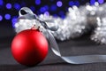 Red christmas ball and blured purple lights at the background Royalty Free Stock Photo