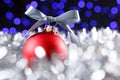 Red christmas ball and blured purple lights at the background Royalty Free Stock Photo