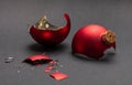 Red Christmas ball broken, dark gray background, closeup view Royalty Free Stock Photo