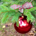 Red Christmas ball with checkered ribon