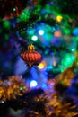 Red Christmas ball decoration hanged up on a Christmas tree with nice blurry background Royalty Free Stock Photo