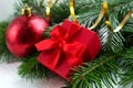 Red christmas ball and gift wih fir branches