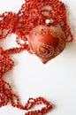 Red Christmas ball with golden decor and beads on a white background. a card for a Merry Christmas and a Happy New Year. Royalty Free Stock Photo