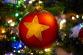 Closeup of a red Christmas bauble hanging on a Christmas tree Royalty Free Stock Photo