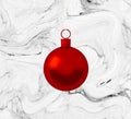 Red christmas ball ornament hanging on marble white background. Holiday concept, new year. Royalty Free Stock Photo