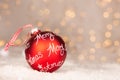 Red christmas ball with text Merry Christmas and bokeh of yellow christmaslights Royalty Free Stock Photo