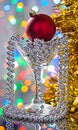Red christmas ball in vineglass with tinsel Royalty Free Stock Photo
