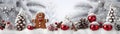 Red Christmas balls, gingerbread piece and pine cones in a row with trees covered with snow. Royalty Free Stock Photo