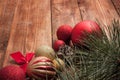 Red christmas balls, pine and cypress cones with twigs on wood t
