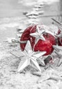 Red christmas balls on snow in front of white and sparkling background Royalty Free Stock Photo