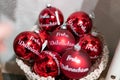 Red christmas balls with the writing `Frohe Weihnachten` on it. Weihnachtskugel mit Frohe Weihnachten.