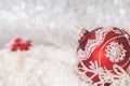 Red Christmas bauble on glitter background Royalty Free Stock Photo