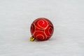 Christmas bauble lying in the snow Royalty Free Stock Photo