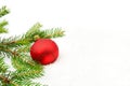 Red christmas bauble with red star and needles fir on snow Royalty Free Stock Photo