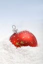Red christmas bauble in the snow Royalty Free Stock Photo