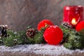 Red Christmas bauble with snow and candle Royalty Free Stock Photo