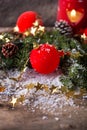 Red Christmas bauble with snow and candle Royalty Free Stock Photo