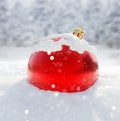 Red Christmas bauble snow covered, snowflake falling, 3d Royalty Free Stock Photo