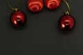 Red Christmas baubles on black background with copy space Royalty Free Stock Photo