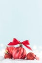 Red Christmas baubles on blue background with snow, copy space Royalty Free Stock Photo