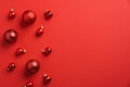 Red Christmas baubles decoration on red background. Flat lay, top view, copy space. New Year greeting card mockup, banner template Royalty Free Stock Photo