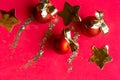 Red Christmas baubles with golden bows on red background. Royalty Free Stock Photo