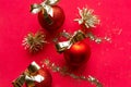 Red Christmas baubles with golden bows on red background. Royalty Free Stock Photo