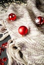 red Christmas baubles on natural wool