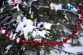 Red Christmas beads and Christmas tree toys decorate the tree branch. Royalty Free Stock Photo