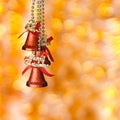 Red Christmas bells on the yellow background Royalty Free Stock Photo