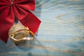 Red Christmas bow golden ball on wooden board copy space holiday Royalty Free Stock Photo