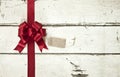 Red Christmas bow and ribbon on old painted white wood background Royalty Free Stock Photo