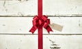 Red Christmas bow and ribbon on old painted white wood background Royalty Free Stock Photo