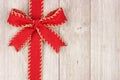 Red Christmas bow and ribbon side border on old white wood Royalty Free Stock Photo