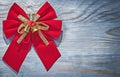 Red Christmas bow on wooden board copy space holidays concept Royalty Free Stock Photo