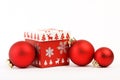 Red christmas box with red Christmas decoration and three red matt christmas balls on white background. Christmas box with christm Royalty Free Stock Photo